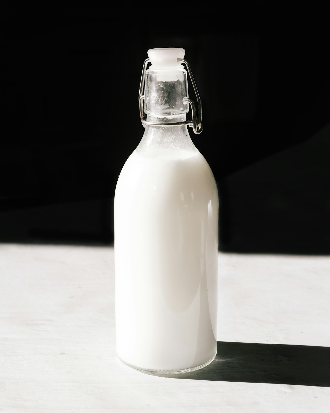 Clear glass bottle of milk on a kitchen counter